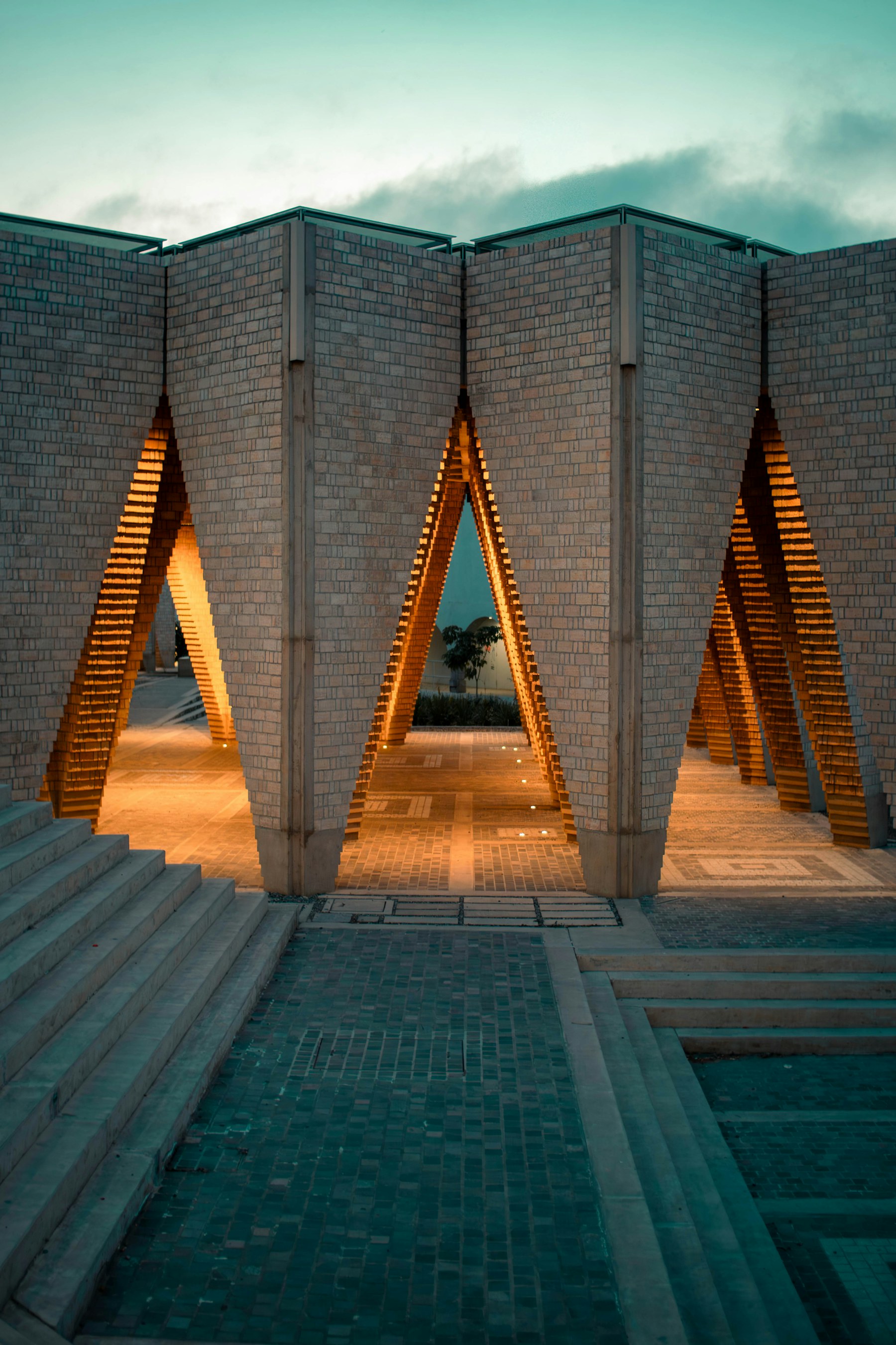 Dusk view of a lit architectural pavilion